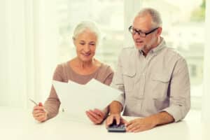 senior couple with papers and calculator at home